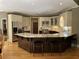 Bright kitchen featuring granite countertops, island with seating, and modern appliances at 605 Meadows Creek Dr, Johns Creek, GA 30005