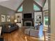 Cozy living room with vaulted ceilings, fireplace, built-ins, and comfortable seating at 605 Meadows Creek Dr, Johns Creek, GA 30005