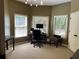 Inviting home office with great natural light from three windows and neutral decor at 605 Meadows Creek Dr, Johns Creek, GA 30005