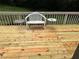 A rustic wooden deck with an outdoor seating area, perfect for relaxing and enjoying nature at 6174 S. Skyline Dr, Douglasville, GA 30135