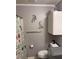 Functional bathroom with a toilet, shower curtain, and storage cabinet at 6174 S. Skyline Dr, Douglasville, GA 30135