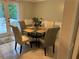 Eat-in kitchen dining area featuring tile floors, neutral paint colors, and a glass-topped table with seating at 6174 S. Skyline Dr, Douglasville, GA 30135