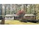 Charming single-story brick home with a well-maintained front yard and mature trees at 6174 S. Skyline Dr, Douglasville, GA 30135