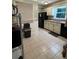 Spacious kitchen area with tile flooring, bright paint, and a window overlooking the yard at 6174 S. Skyline Dr, Douglasville, GA 30135