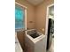 Functional laundry room featuring a washer and dryer with a utility sink and storage cabinets at 6174 S. Skyline Dr, Douglasville, GA 30135