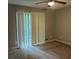 Bedroom with vertical blinds, a ceiling fan, neutral paint, and dirty carpet at 1701 Charmeth Rd, Lithonia, GA 30058