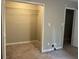 Bedroom with open closet, neutral paint, and carpet at 1701 Charmeth Rd, Lithonia, GA 30058