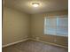 This bedroom features a window with blinds, neutral paint, and a ceiling light at 1701 Charmeth Rd, Lithonia, GA 30058