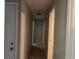 Hallway showing doors to rooms at 1701 Charmeth Rd, Lithonia, GA 30058