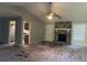 Open living room with a stone fireplace and a view of the kitchen at 1701 Charmeth Rd, Lithonia, GA 30058