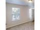 Neutral bedroom featuring carpet floors, a ceiling light and multiple windows at 364 Springhaven Way, Lawrenceville, GA 30046
