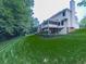 Exterior backyard view shows well-manicured lawn, stone retaining wall, house exterior, and tall trees at 4271 Edgewater Drive Northwest Nw Dr, Kennesaw, GA 30144