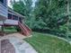 Exterior backyard view showcases a patio, stairs, walkway, lush lawn, and mature trees at 4271 Edgewater Drive Northwest Nw Dr, Kennesaw, GA 30144