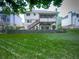 Expansive backyard view showcases lush greenery, stone retaining wall, deck and house exterior at 4271 Edgewater Drive Northwest Nw Dr, Kennesaw, GA 30144