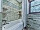 Bathroom featuring a shower and tub and textured stone-style backsplash at 4271 Edgewater Drive Northwest Nw Dr, Kennesaw, GA 30144