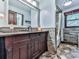 Bathroom featuring a dark wood vanity, stone-look floor, and shower with tub at 4271 Edgewater Drive Northwest Nw Dr, Kennesaw, GA 30144