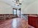 Bedroom with ceiling fan, hardwood floors and decorative brick-style wainscoting at 4271 Edgewater Drive Northwest Nw Dr, Kennesaw, GA 30144