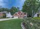 Charming two-story brick home with a well-manicured lawn and colorful flower bushes at 4271 Edgewater Drive Northwest Nw Dr, Kennesaw, GA 30144