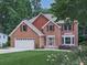 Traditional two-story brick home with a well-manicured lawn, mature trees and an attached two-car garage at 4271 Edgewater Drive Northwest Nw Dr, Kennesaw, GA 30144
