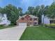 Traditional two-story brick home with a well-manicured lawn, mature trees and an attached two-car garage at 4271 Edgewater Drive Northwest Nw Dr, Kennesaw, GA 30144