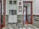 Hallway view with tile flooring, brick accent wall, and open doorway at 4271 Edgewater Drive Northwest Nw Dr, Kennesaw, GA 30144