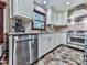 Bright kitchen featuring stainless steel appliances, stone tile floors, and stone countertops at 4271 Edgewater Drive Northwest Nw Dr, Kennesaw, GA 30144
