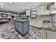 Bright kitchen featuring an island, stone tile floors, stainless steel appliances, and stone countertops at 4271 Edgewater Drive Northwest Nw Dr, Kennesaw, GA 30144