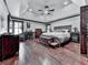 Primary bedroom with hardwood floors, ceiling fan, large window, and furniture at 4271 Edgewater Drive Northwest Nw Dr, Kennesaw, GA 30144