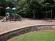 Community playground featuring slides and swings, set against a backdrop of mature trees and landscaping at 4271 Edgewater Drive Northwest Nw Dr, Kennesaw, GA 30144