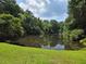 Scenic view of a tranquil pond surrounded by lush greenery and trees, reflecting the sky at 4271 Edgewater Drive Northwest Nw Dr, Kennesaw, GA 30144