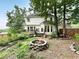 View of backyard with fire pit, deck, and mature trees creates a tranquil outdoor space at 4715 Scotney Ct, Suwanee, GA 30024