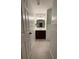 Bathroom with wainscoting, neutral color palette, a single sink vanity, and tile floors at 4715 Scotney Ct, Suwanee, GA 30024