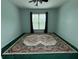 Spacious bedroom with a decorative rug, neutral paint, and dark drapery at 4715 Scotney Ct, Suwanee, GA 30024