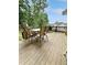 Outdoor deck with a dining table, chairs, and grill, perfect for entertaining or enjoying outdoor meals at 4715 Scotney Ct, Suwanee, GA 30024