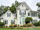 Charming two-story house with stucco siding, a manicured lawn, and lush landscaping at 4715 Scotney Ct, Suwanee, GA 30024