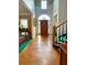 Bright foyer with hardwood floors, high ceilings, and staircase with a wooden railing at 4715 Scotney Ct, Suwanee, GA 30024