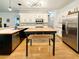 Modern kitchen featuring stainless steel appliances, white cabinetry, and a tile backsplash at 4715 Scotney Ct, Suwanee, GA 30024