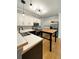 Well-lit kitchen with stainless steel appliances, white cabinetry, and a kitchen island at 4715 Scotney Ct, Suwanee, GA 30024