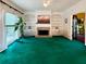 Bright living room with built-in shelving, a stone fireplace, and large windows at 4715 Scotney Ct, Suwanee, GA 30024