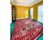 Stylish living room with a large rug, bright yellow walls, and natural light at 4715 Scotney Ct, Suwanee, GA 30024