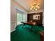 Spacious office with a large wooden desk, bay windows, and plush green carpet at 4715 Scotney Ct, Suwanee, GA 30024
