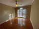 Cozy bedroom with hardwood floors and large window for natural light at 5005 Johns Creek Ct, Alpharetta, GA 30022