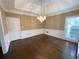 Elegant dining room with hardwood floors, wainscoting, chandelier, and natural light at 5005 Johns Creek Ct, Alpharetta, GA 30022