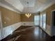 Dining room features a tray ceiling, hardwood floors, and wainscotting at 5005 Johns Creek Ct, Alpharetta, GA 30022