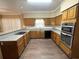 Well-equipped kitchen with granite countertops, wood cabinets, and stainless steel appliances at 5005 Johns Creek Ct, Alpharetta, GA 30022