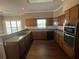 Well-lit kitchen features granite countertops and stainless steel double oven at 5005 Johns Creek Ct, Alpharetta, GA 30022