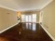 Bright living room featuring hardwood floors, neutral wall color, and natural light at 5005 Johns Creek Ct, Alpharetta, GA 30022