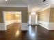 Spacious living room with hardwood floors, crown molding, and bright entryway at 5005 Johns Creek Ct, Alpharetta, GA 30022