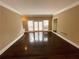 Bright living room featuring hardwood floors, neutral paint, and direct patio access at 5005 Johns Creek Ct, Alpharetta, GA 30022