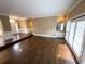 Spacious living room with hardwood floors, wet bar, and large windows overlooking the backyard at 5005 Johns Creek Ct, Alpharetta, GA 30022